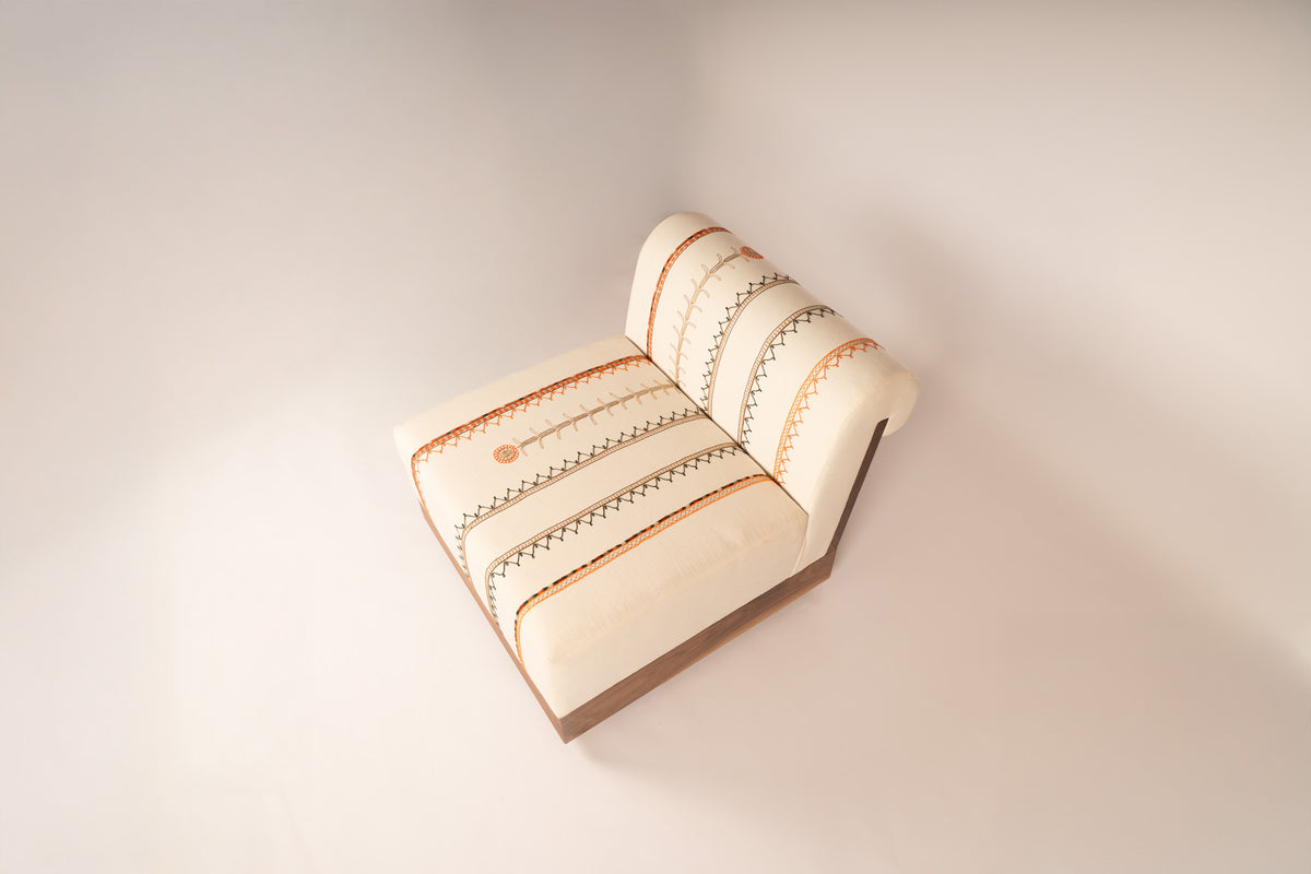 Lounge chair with Tahriri embroidery and a solid walnut base